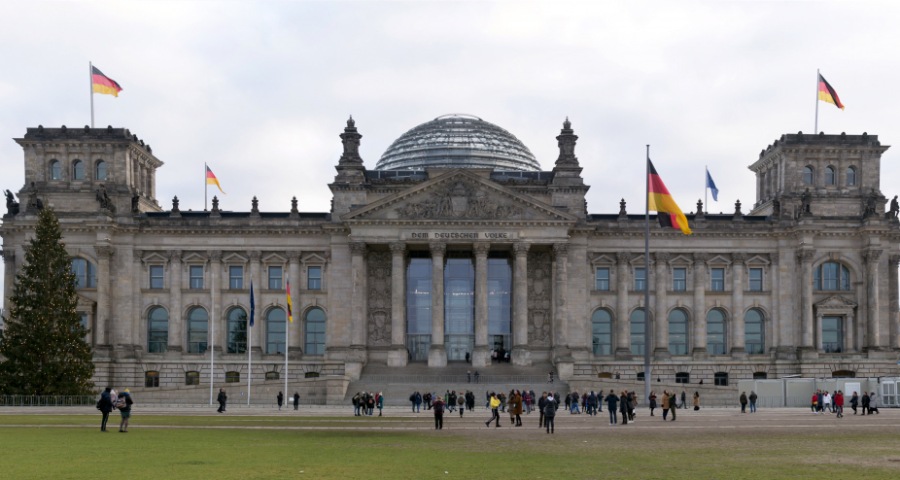 An image showing a German university campus surrounded by students.