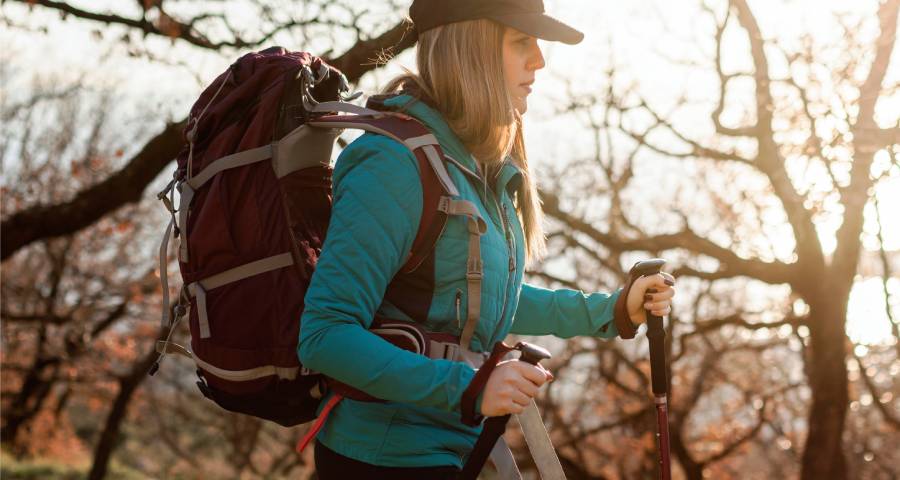indian women walking with backpack on trek
