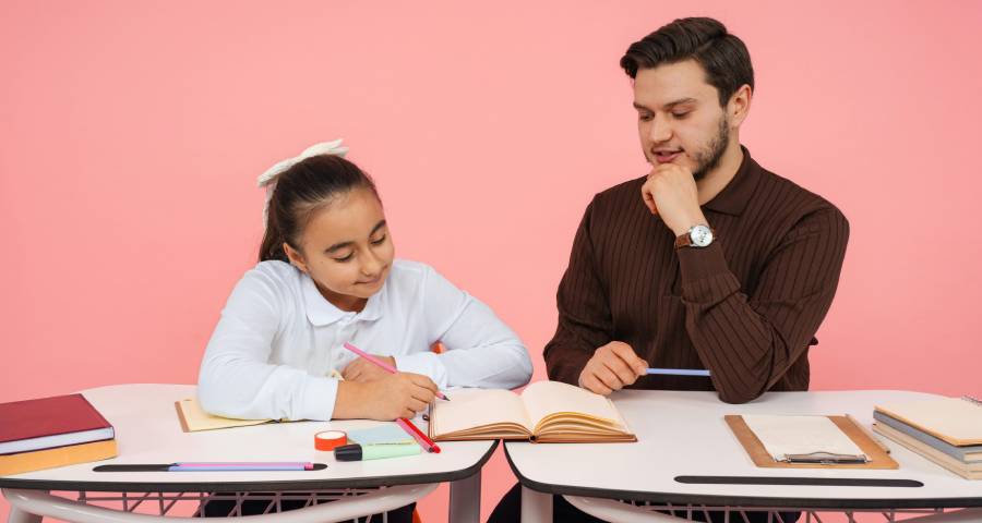 Student and teacher in a close one on one classroom conversation — building the relationship that leads to a specific powerful recommendation