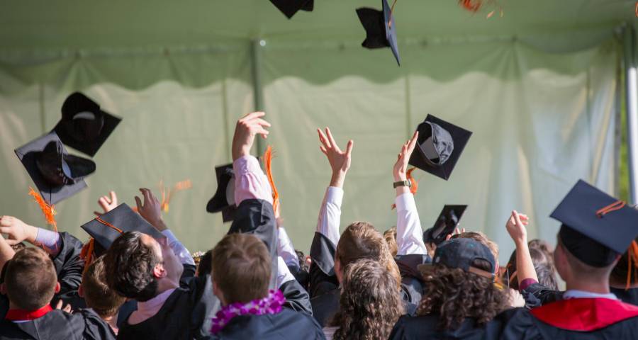 Students celebrating graduation success after navigating Ivy League admissions authentically