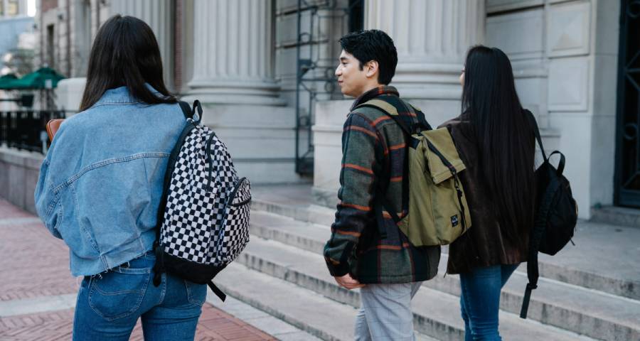 Diverse university students walking together on campus — representing Indian students building their new life abroad at an Ivy League university