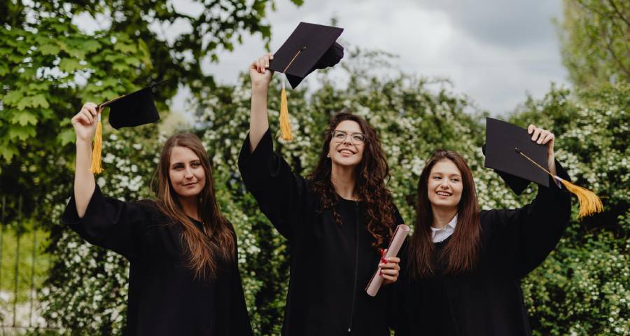 Students celebrating graduation success after building a strong profile and personal brand