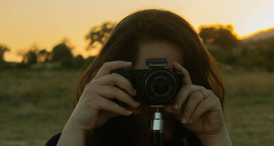 Young WOMEN with camera exploring a coastal landscape — purposeful exploration during a gap year builds real life experience