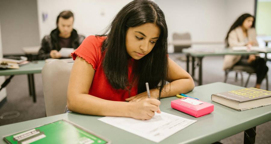 University students focused on answering exam questions — the discipline needed to excel at TOEFL or IELTS for Ivy League university applications from India