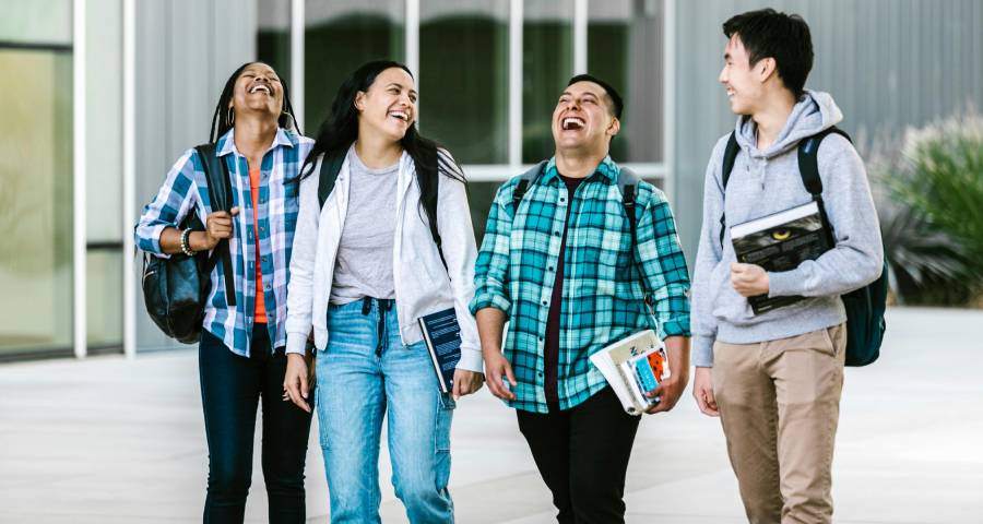 Diverse group of students laughing and walking together on campus — the friendships Indian students build abroad that last a lifetime