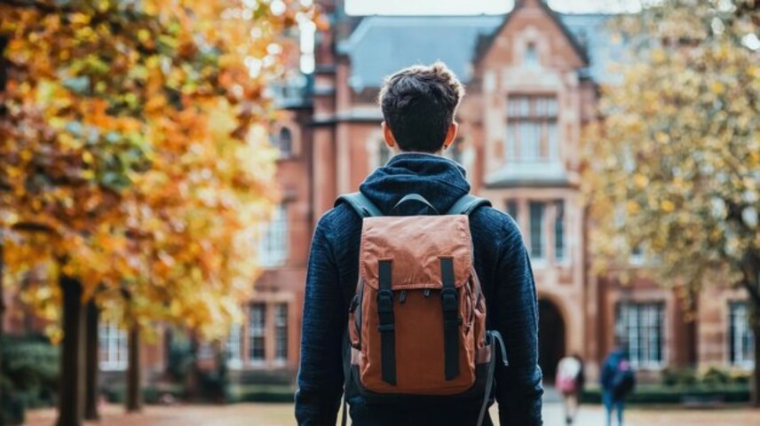 study abroad consultant Ahmedabad Student walking through university campus with backpack